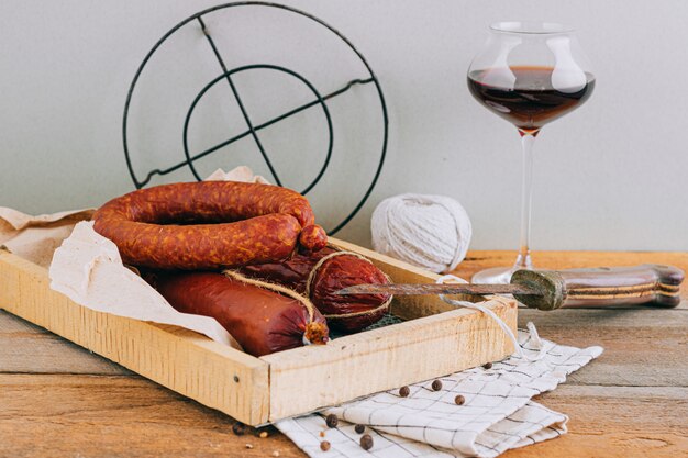 Assorted smoked sausages, appetizer to red wine on wood