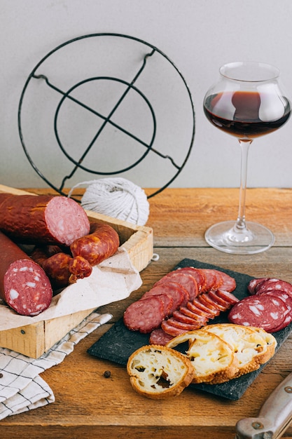 Assorted smoked sausages, appetizer to red wine on wood