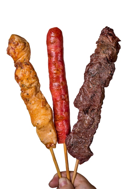 Assorted steak skewers on white background