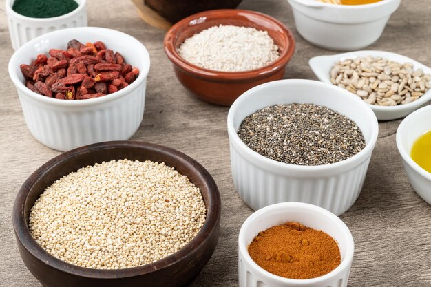assorted superfoods in over stone background chia quinoa oat linseed honey spirulina and others