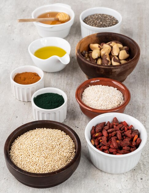 assorted superfoods in over wooden background chia quinoa oat linseed honey spirulina and others