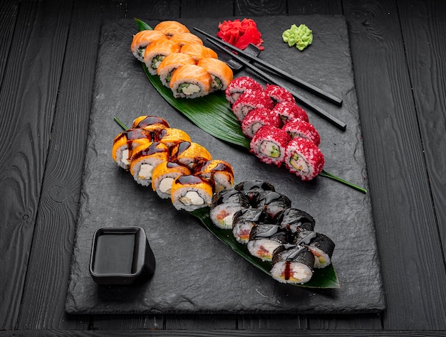 Assorted sushi nigiri and maki big set on slate A variety of Japanese sushi with tuna crab salmon eel and rolls