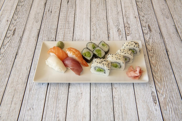 Assorted sushi platter with uramaki california roll with avocado and nori seaweed seaweed maki shrimp nigiri butterfish and salmon marinated with bluefin tuna
