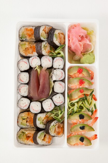 Assorted sushi set served with chopsticks in white box