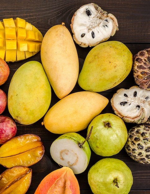 Assorted thai tropical fruits on a dark wooden rustic background