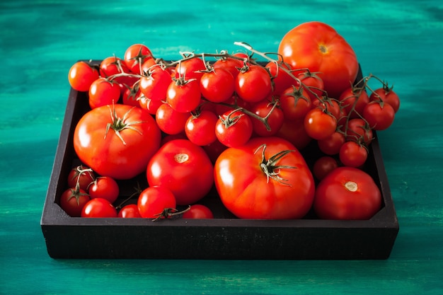 Assorted tomatoes in wooden box