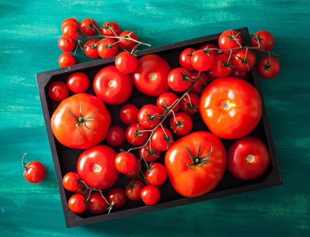 Assorted tomatoes in wooden box