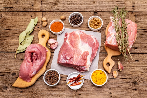 Assorted various fresh pork cuts. Raw meat with spices. Tenderloin, shoulder blade, neck