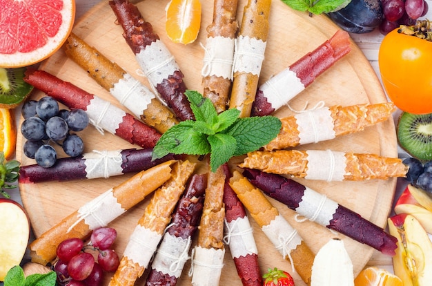 Assortied dried chips and ripe fruits on grey background. Fruit chips. Healthy eating concept, snack, no sugar. Top view, copy space.