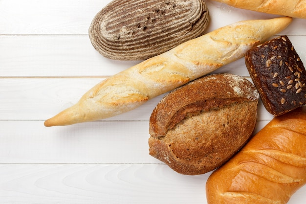 Assortment of baked bread on wood table