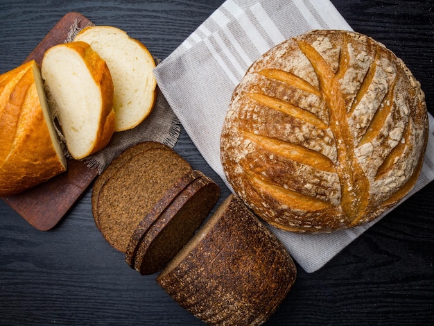 Assortment of baked bread on wooden background