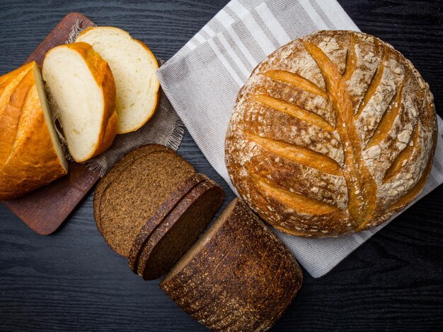 Assortment of baked bread on wooden background