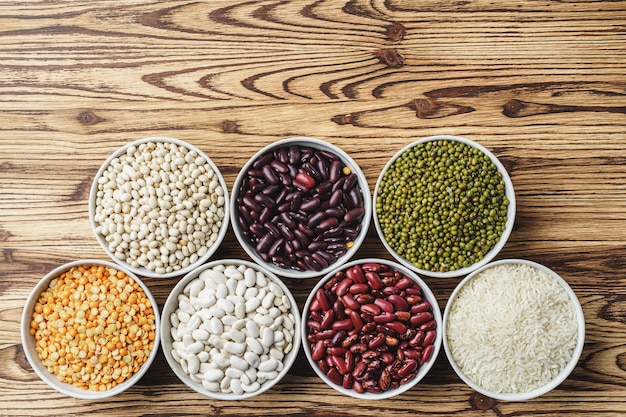 Assortment of beans on wooden background. Close up.