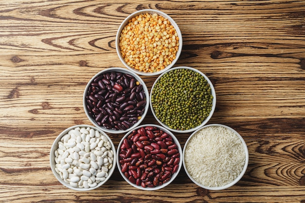 Assortment of beans on wooden background. Close up.