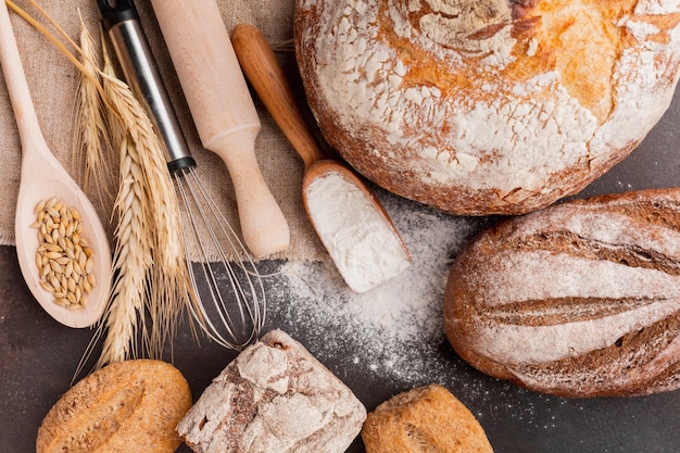 Assortment of bread with whisk and wooden spoon