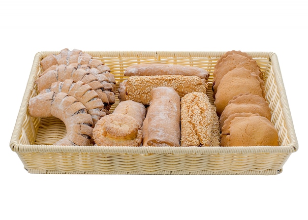 Assortment of buns in a basket of different varieties on a white isolated background.