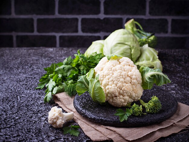 Assortment of cabbages on concrete background