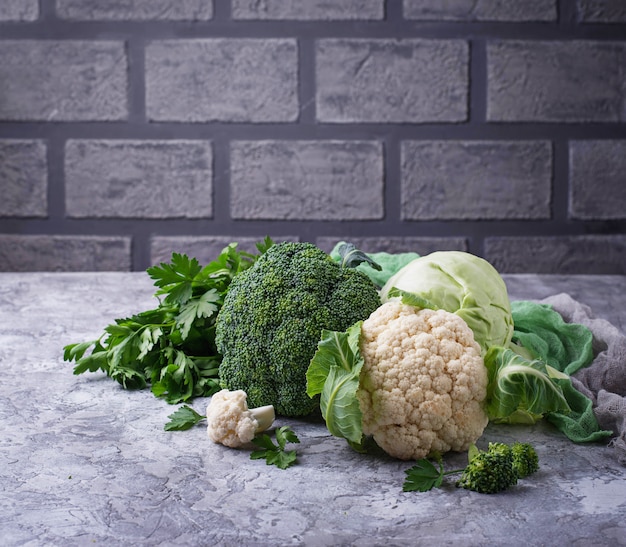 Assortment of cabbages on concrete background