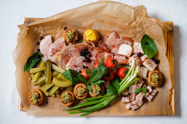 Assortment of canapes with meat Banquet service catering food snacks with cheese jamon prosciutto and fruit Snacks for buffet at the reception