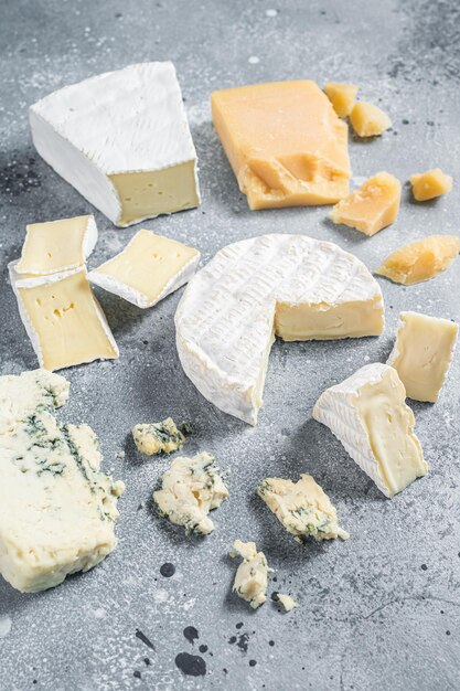 Assortment of cheese camembert brie blue cheese parmesan gray\
background top view