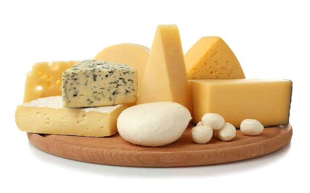 assortment of cheese on wooden board isolated on white