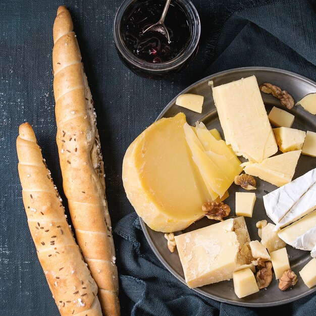 assortment of cheese on wooden board