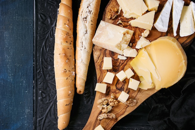 Assortment of cheese on wooden board