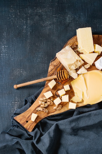 Assortment of cheese on wooden board