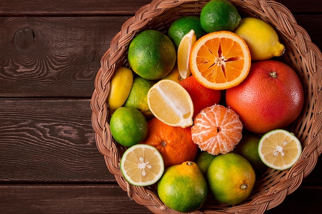 Assortment citrus fruits in a basket closeup top view no people