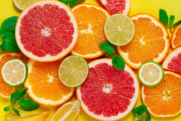 assortment of citrus fruits, on a yellow background, top view, no people, horizontal,