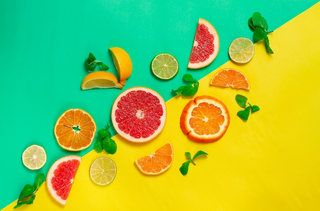 assortment of citrus fruits, on a yellow green background, no people, horizontal