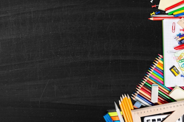 Assortment of colored school supplies on desk