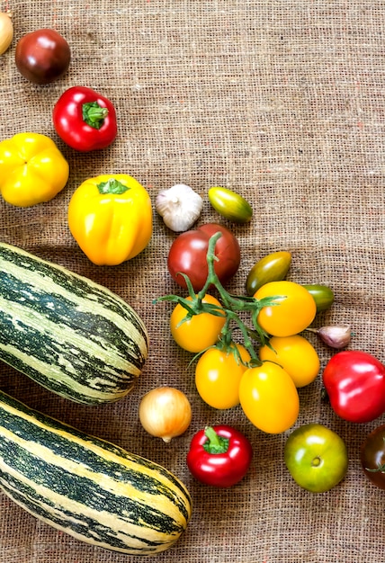 Assortment of colorful fresh vegetables on sackcloth background. Flat lay, top view. Copy space.