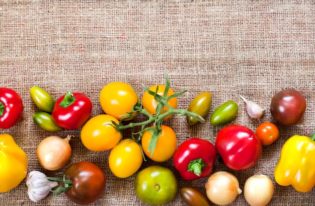 Assortment of colorful fresh vegetables on sackcloth surface