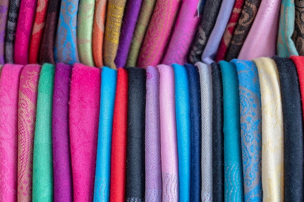 Assortment of colorful sarongs for sale in local market Island Bali Ubud Indonesia Close up