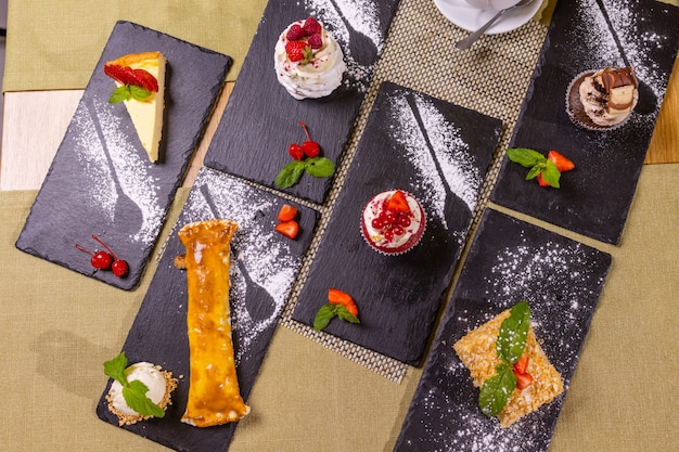 Assortment of confectionery different types of cakes and desserts on the table