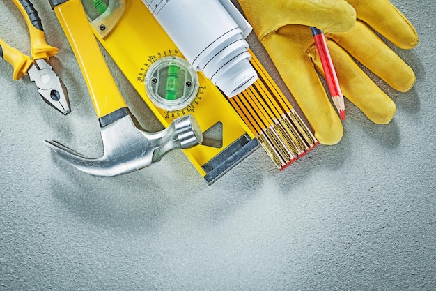 Assortment of construction tools on concrete background building concept.