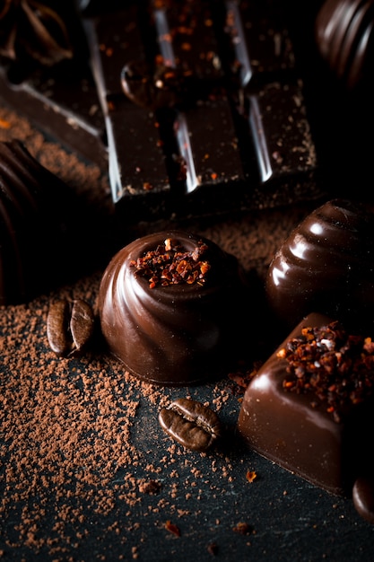 Photo assortment of dark, white and milk chocolate on rustic wooden sacking background.