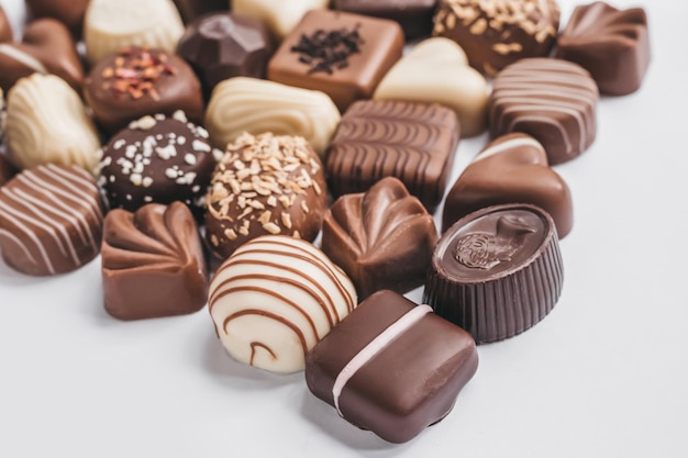 Assortment of dark white and milk chocolate on white background