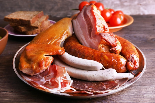 Assortment of deli meats on wooden background