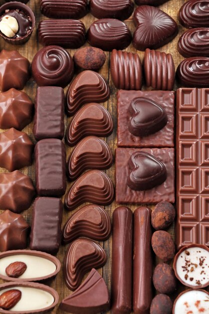 Assortment of delicious chocolate candies background, close up