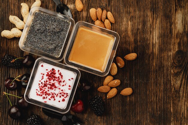 Assortment of delicious dessert boxes on wooden table 