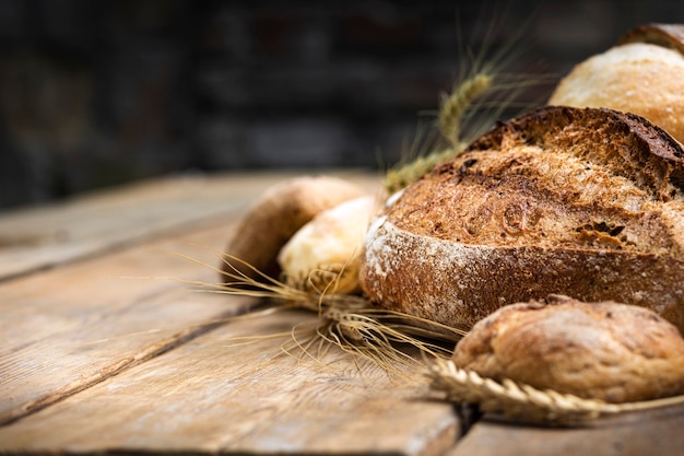 Assortment of different types of bread from rye and wheat flour on a wooden table in a bakery. ÃÂÃÂ¡opy space