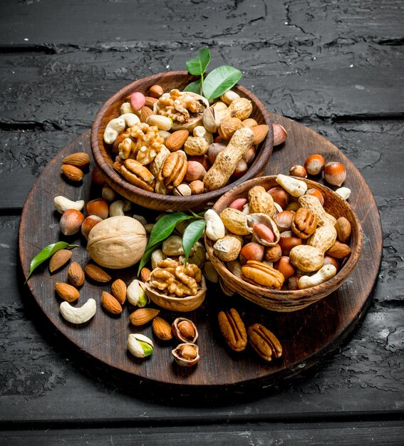 Photo assortment of different types of nuts in bowls