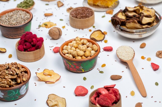 Assortment of dried fruits nuts and seeds on white background