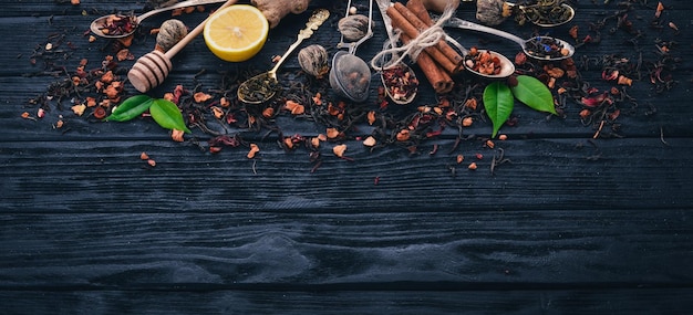 Assortment of dry teas and fragrant herbs and spices On a wooden background Top view Copy space