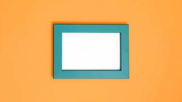 Photo assortment of empty blue frame on wall