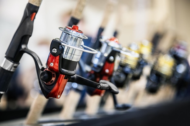 An assortment of fishing reels on the counter of a fishing shop