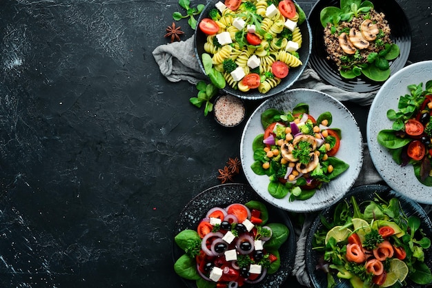 Assortment of food Folk cuisine on a black wooden background Top view Free space for your text Flat lay