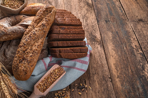 Assortment of fresh bread on a wooden background. Side view, copy space. Bakery products.